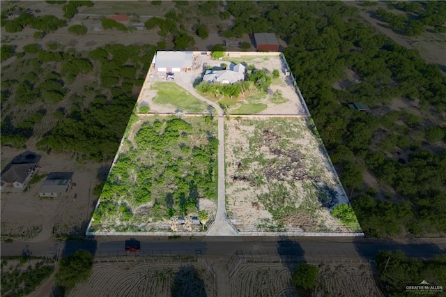 birds eye view of property with a rural view