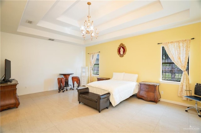 bedroom featuring visible vents, baseboards, a raised ceiling, and a chandelier
