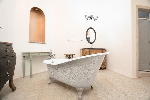 bathroom featuring tile patterned flooring, a sink, and a stall shower