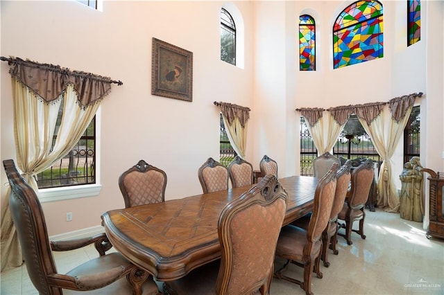 dining area with a high ceiling and baseboards