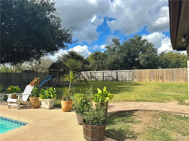 view of yard featuring a playground and a patio