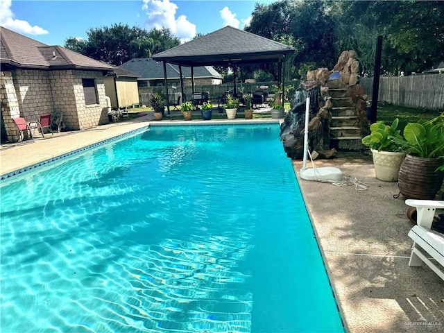 view of swimming pool featuring a gazebo and a patio area