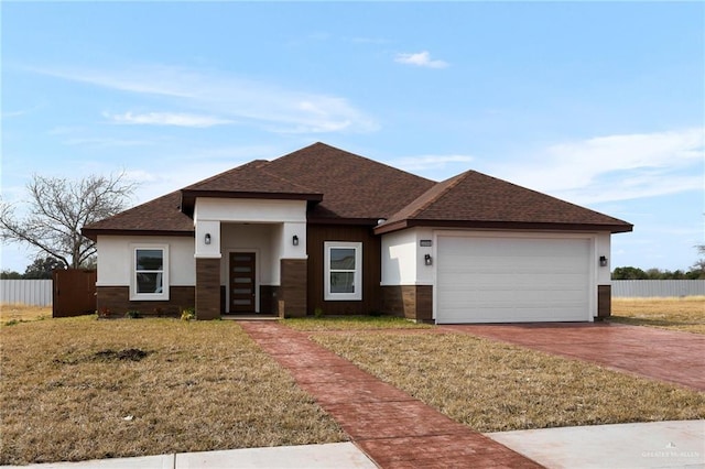 view of front facade with a garage and a front lawn