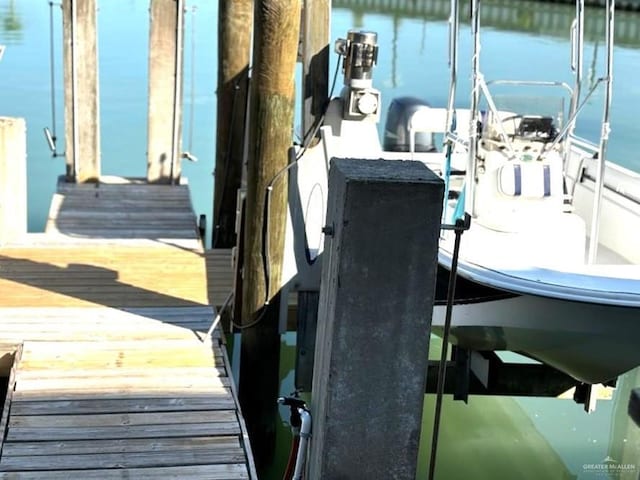 dock area with a water view and boat lift