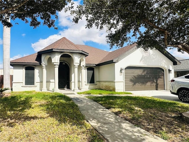 view of front of house featuring a garage and a front lawn