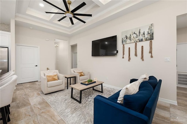 living room with a tray ceiling, ceiling fan, coffered ceiling, and ornamental molding