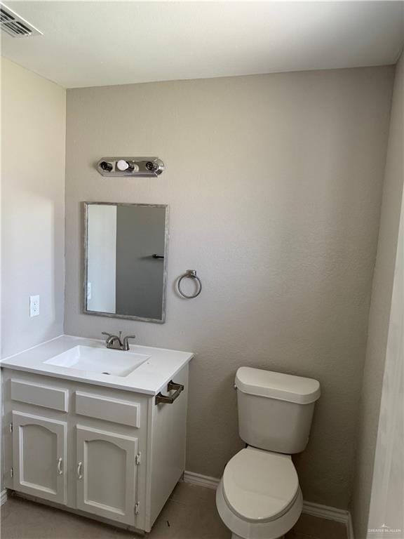 1401 Royola St, Mission, TX 78572 - bathroom with vanity, toilet, baseboards, and tile patterned floors