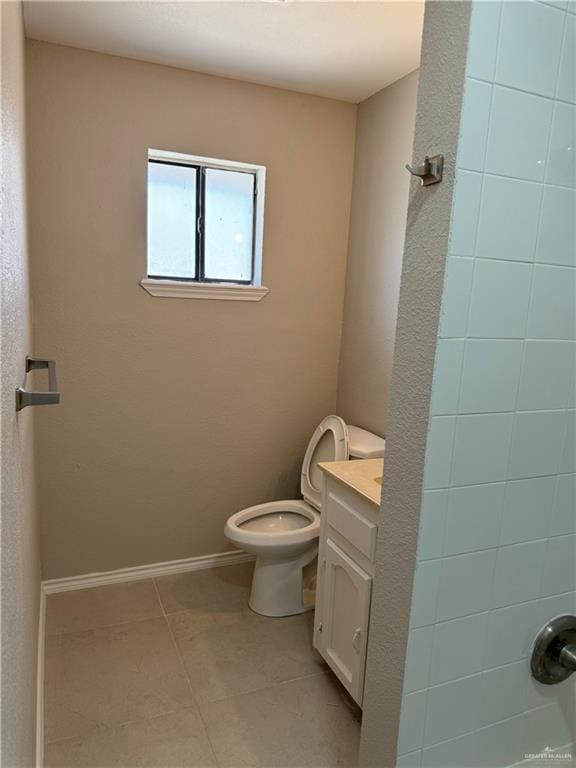 bathroom featuring tile patterned floors, vanity, and toilet