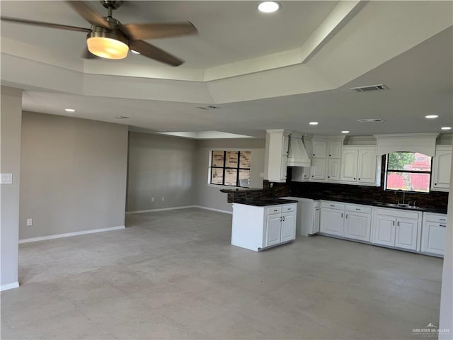 1401 Royola St, Mission, TX 78572 - kitchen with a sink, open floor plan, a raised ceiling, white cabinets, and baseboards