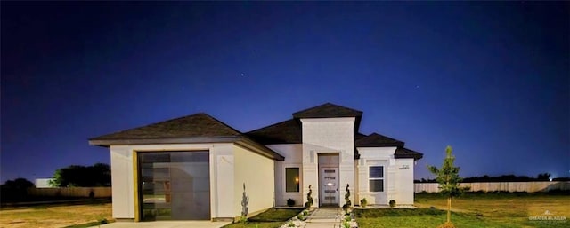 view of front facade featuring a garage, concrete driveway, and a lawn