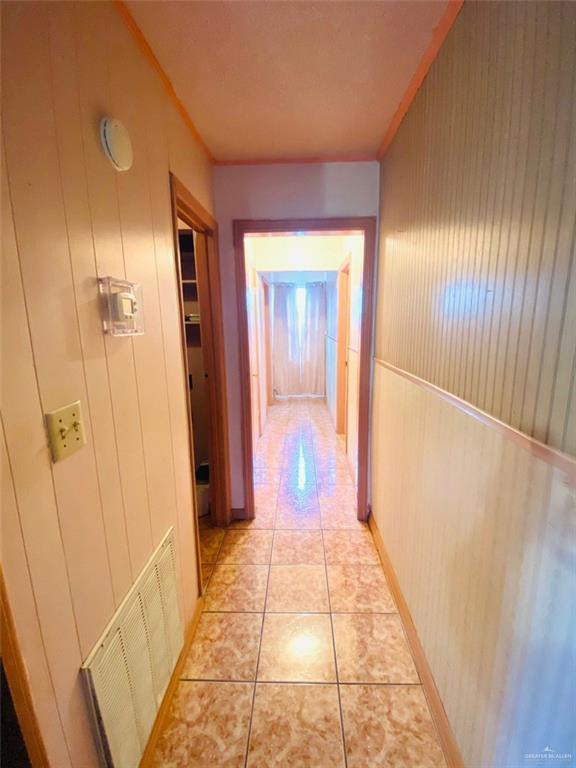 1204 E 2nd St, Weslaco, TX 78596 - corridor featuring light tile patterned flooring