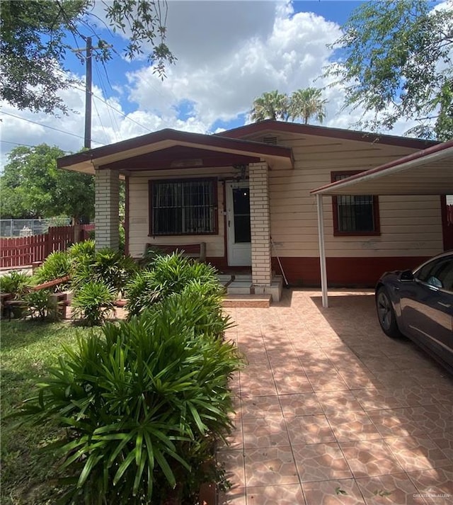 1204 E 2nd St, Weslaco, TX 78596 - view of front facade featuring an attached carport