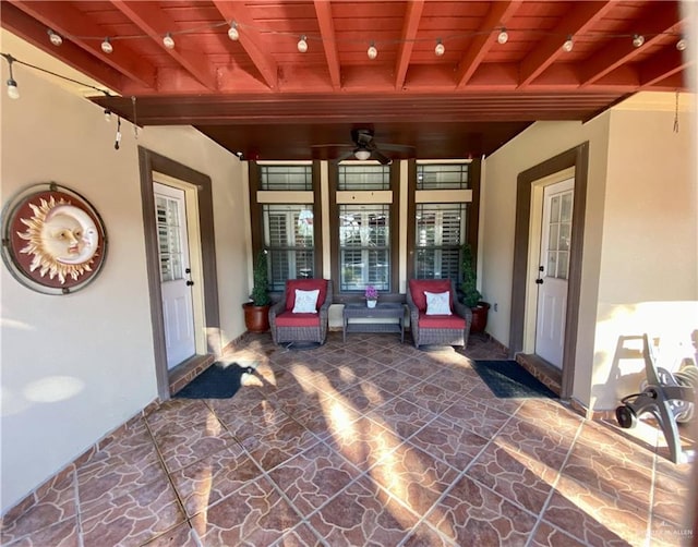 entrance to property featuring a patio area and ceiling fan