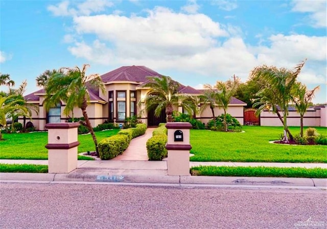 mediterranean / spanish house with a front yard