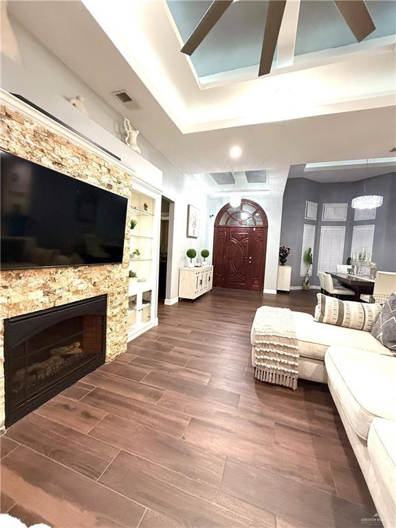 living room with hardwood / wood-style flooring and built in features