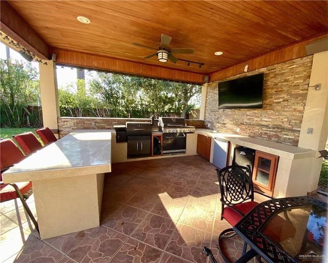 view of patio / terrace with an outdoor kitchen, ceiling fan, sink, and a grill