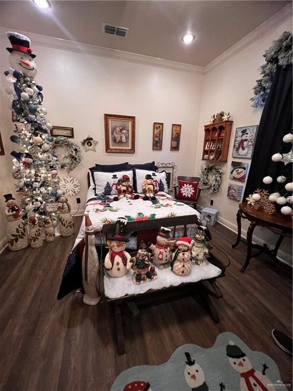 bedroom with crown molding and hardwood / wood-style flooring