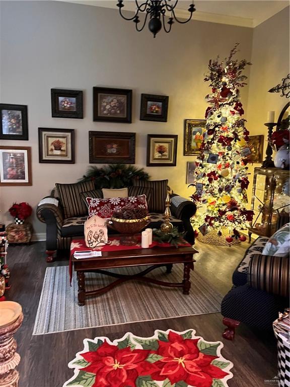 living room featuring dark hardwood / wood-style flooring and a notable chandelier