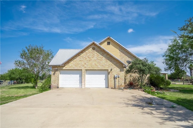 view of front of property with a front yard and a garage