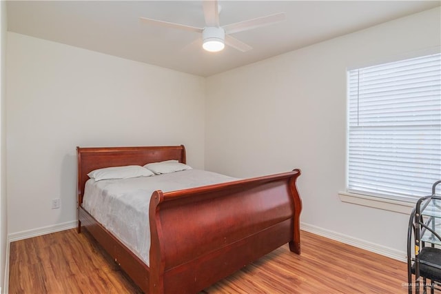 4116 N Flores St, Edinburg, TX 78541 - bedroom with wood finished floors, baseboards, and a ceiling fan