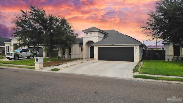 view of front of property featuring a garage and a yard