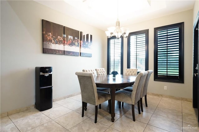 tiled dining space with a chandelier and a healthy amount of sunlight