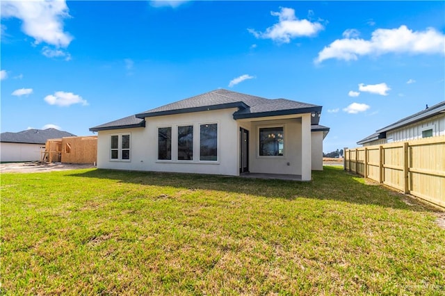 back of property with a patio area and a lawn