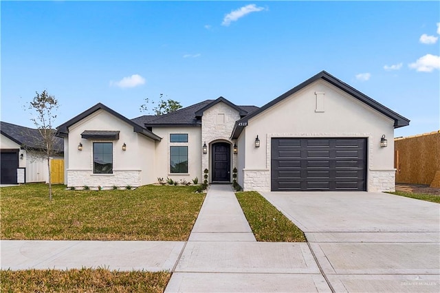 view of front of house featuring a garage and a front lawn