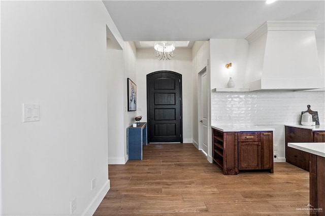 interior space with a notable chandelier and light hardwood / wood-style floors