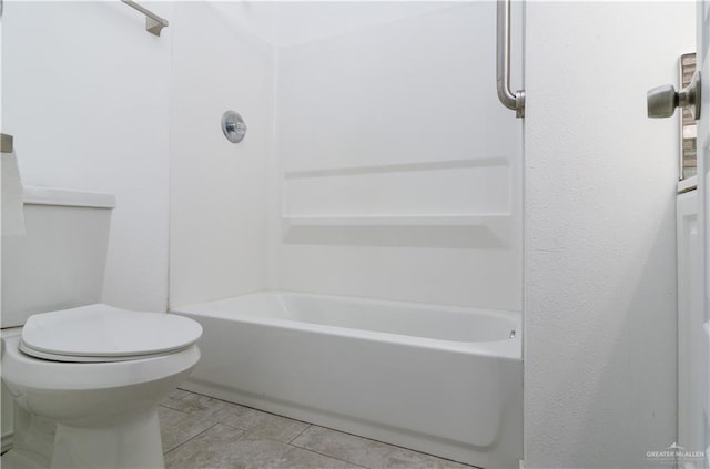 bathroom featuring shower / tub combination, tile patterned flooring, and toilet