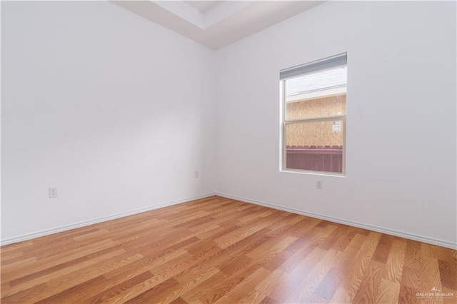 empty room with light hardwood / wood-style flooring