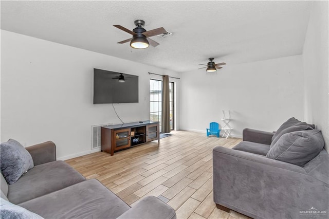 living room with light wood-type flooring and ceiling fan