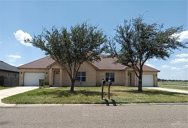 ranch-style house featuring a front lawn and a garage