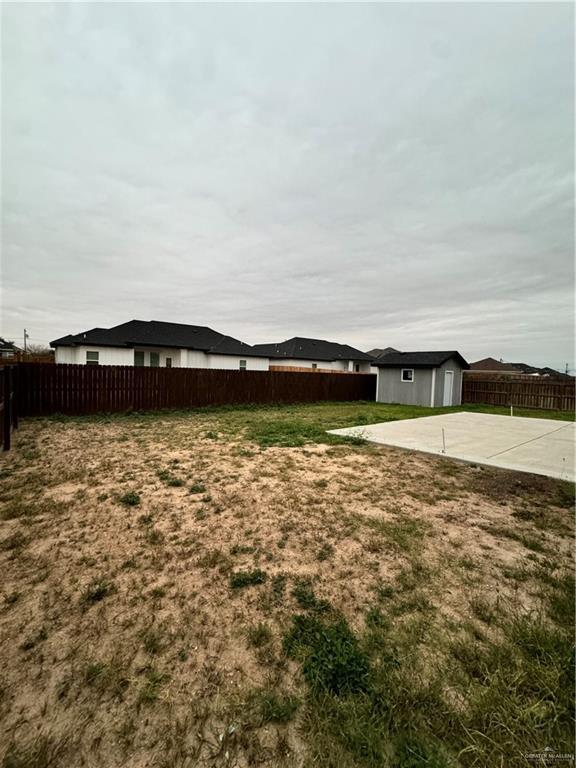 view of yard featuring an outdoor structure and a patio area