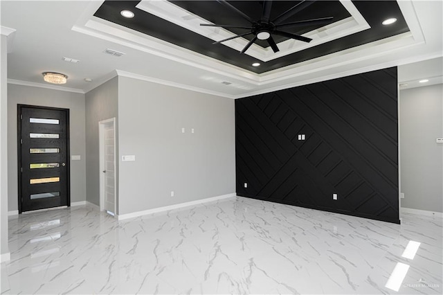 spare room featuring crown molding, ceiling fan, and a tray ceiling