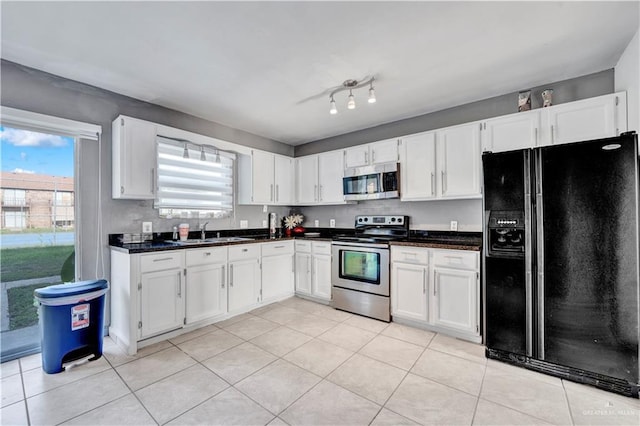 2201 S Jackson Road I Unit 7, Pharr, TX 78577 - kitchen with stainless steel appliances, a sink, dark countertops, and white cabinetry