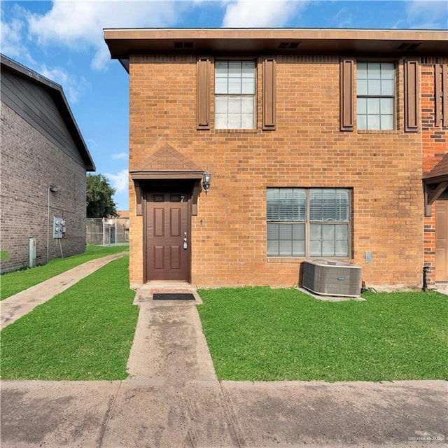 2201 S Jackson Road I Unit 7, Pharr, TX 78577 - view of front of house featuring central air condition unit, a front lawn, and brick siding
