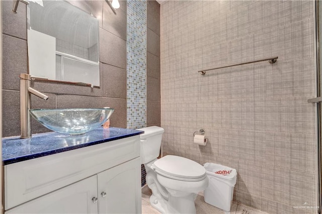 2201 S Jackson Road I Unit 7, Pharr, TX 78577 - bathroom with tile walls, vanity, toilet, tile patterned floors, and a shower