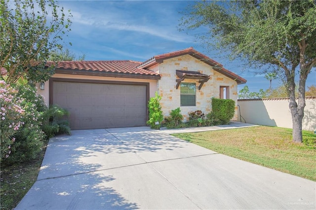 mediterranean / spanish house with a front yard, concrete driveway, fence, a tiled roof, and a garage