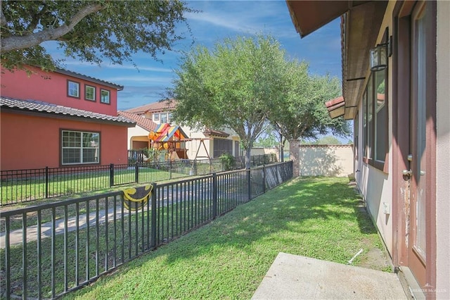view of yard with a fenced backyard and a playground