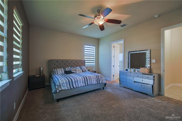 bedroom with baseboards, visible vents, carpet floors, and a ceiling fan