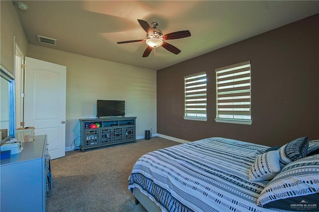carpeted bedroom with baseboards, visible vents, and a ceiling fan