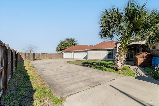 exterior space with a front lawn, fence, and stucco siding