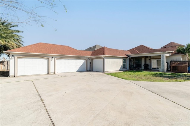 view of front of home with driveway, an attached garage, and a front yard