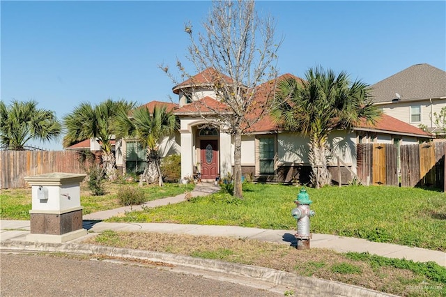 view of front of property with a front yard and fence