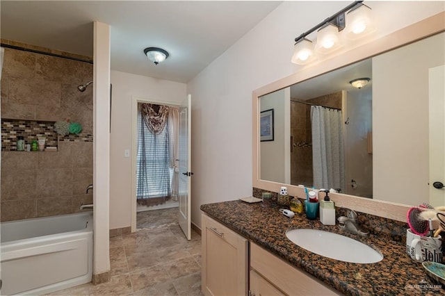 full bath featuring shower / bath combo with shower curtain, vanity, and baseboards