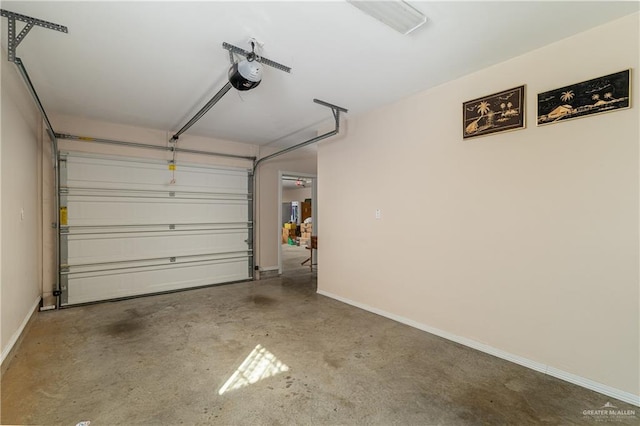 garage with a garage door opener and baseboards