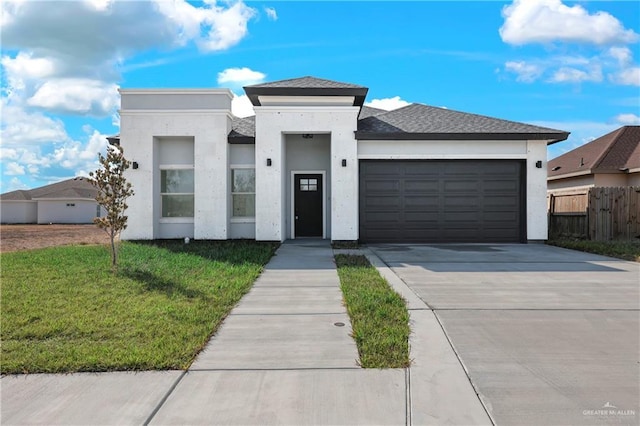 view of front of home featuring a garage and a front yard