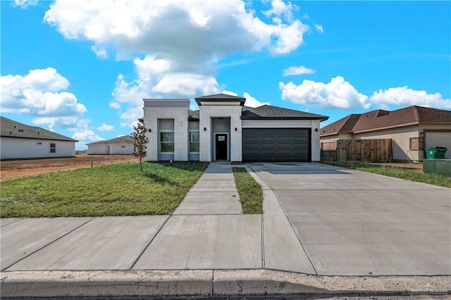 view of front of property featuring a garage and a front lawn