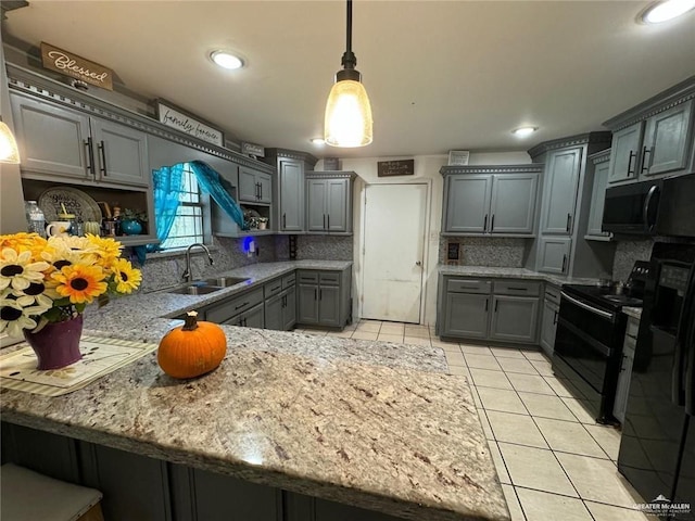 kitchen featuring pendant lighting, gray cabinetry, black appliances, sink, and light tile patterned floors